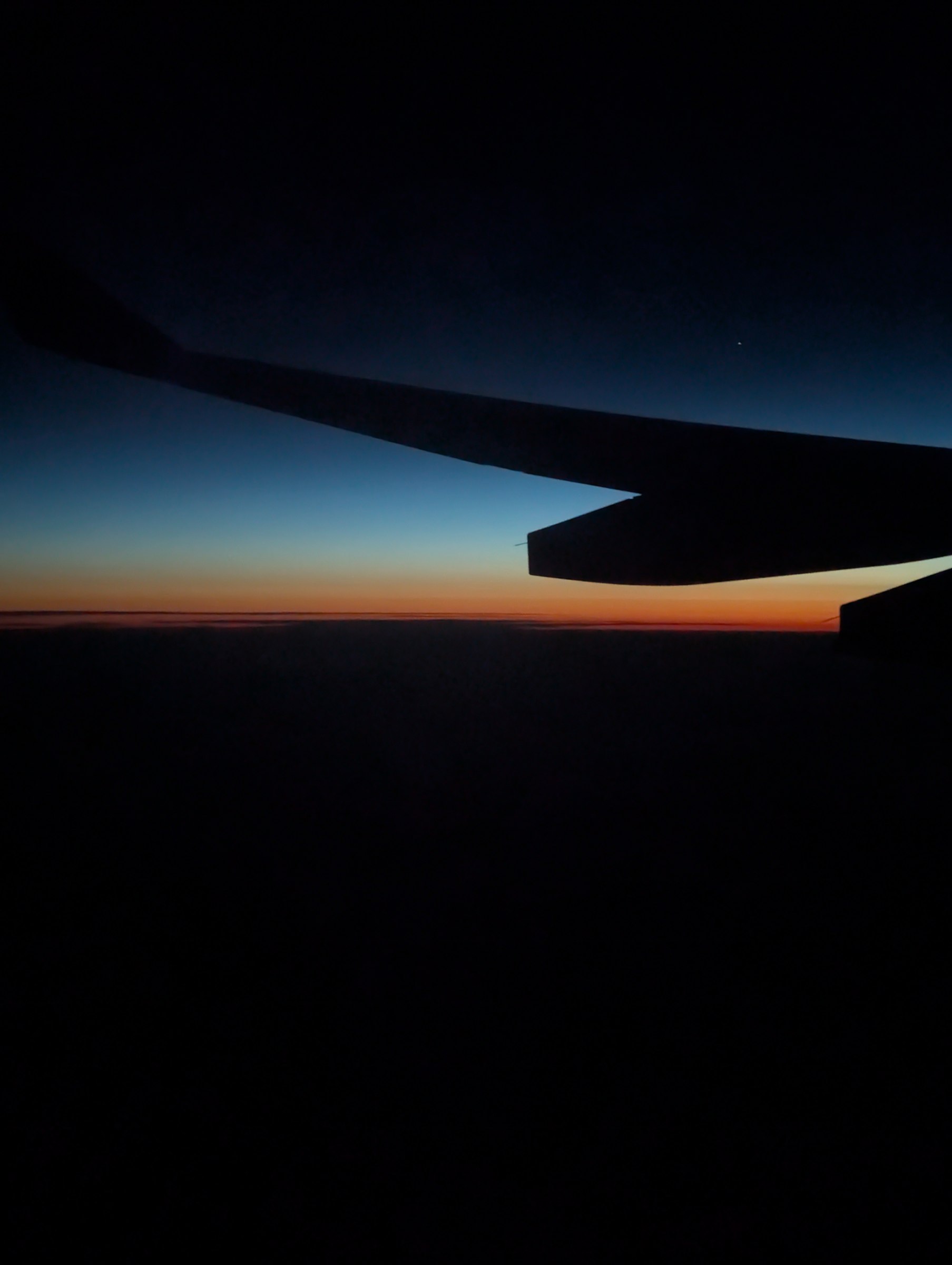 Airplane wing at sunrise