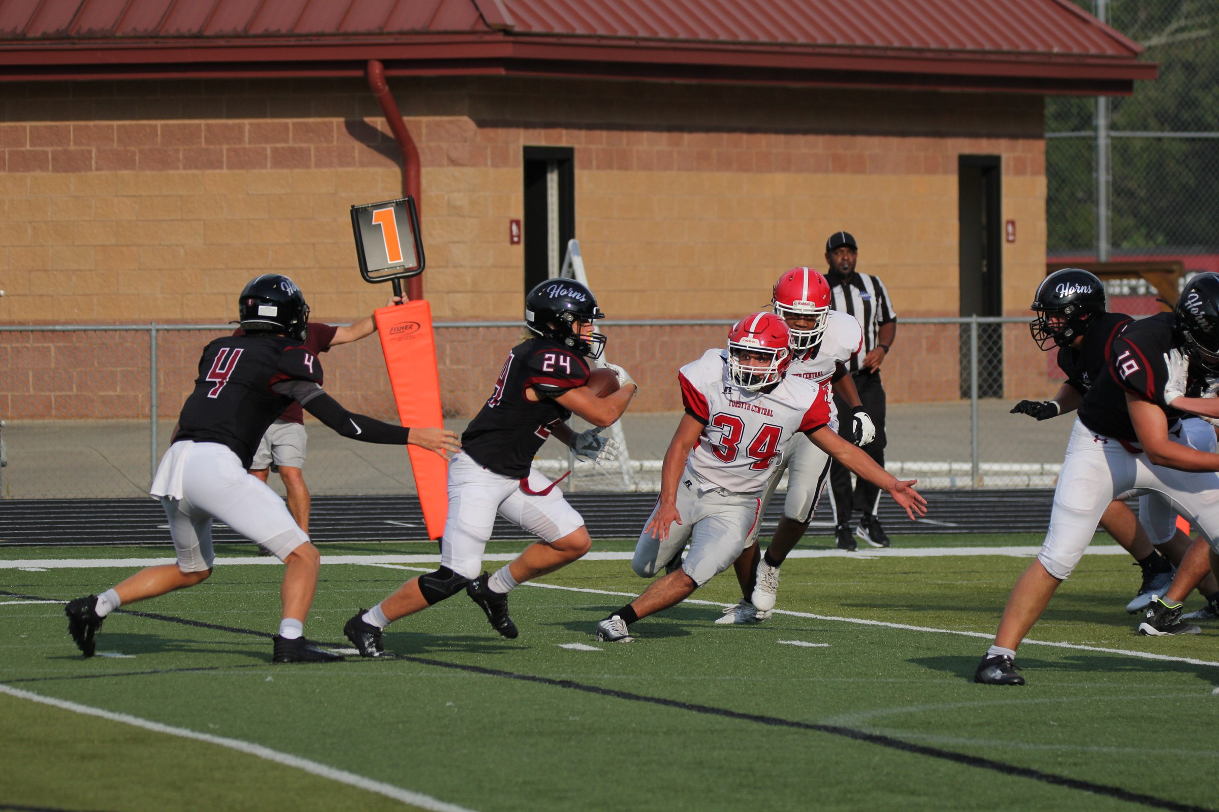 Running back breaking a tackle